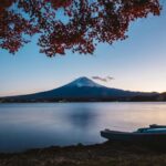 Capture the beauty of Mount Fuji with vibrant autumn leaves at Lake Kawaguchi during twilight.